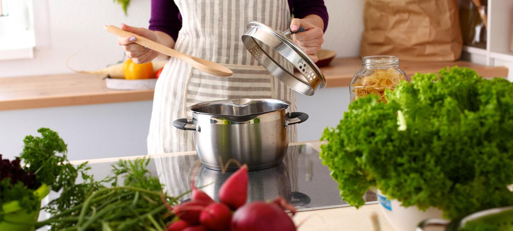 woman cooking with fresh ingredients in kitchen